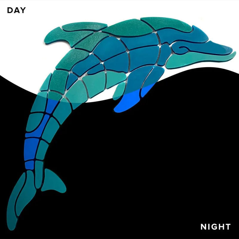 Playful Dolphin glow-in-the-dark pool mosaic shown in daylight and at night