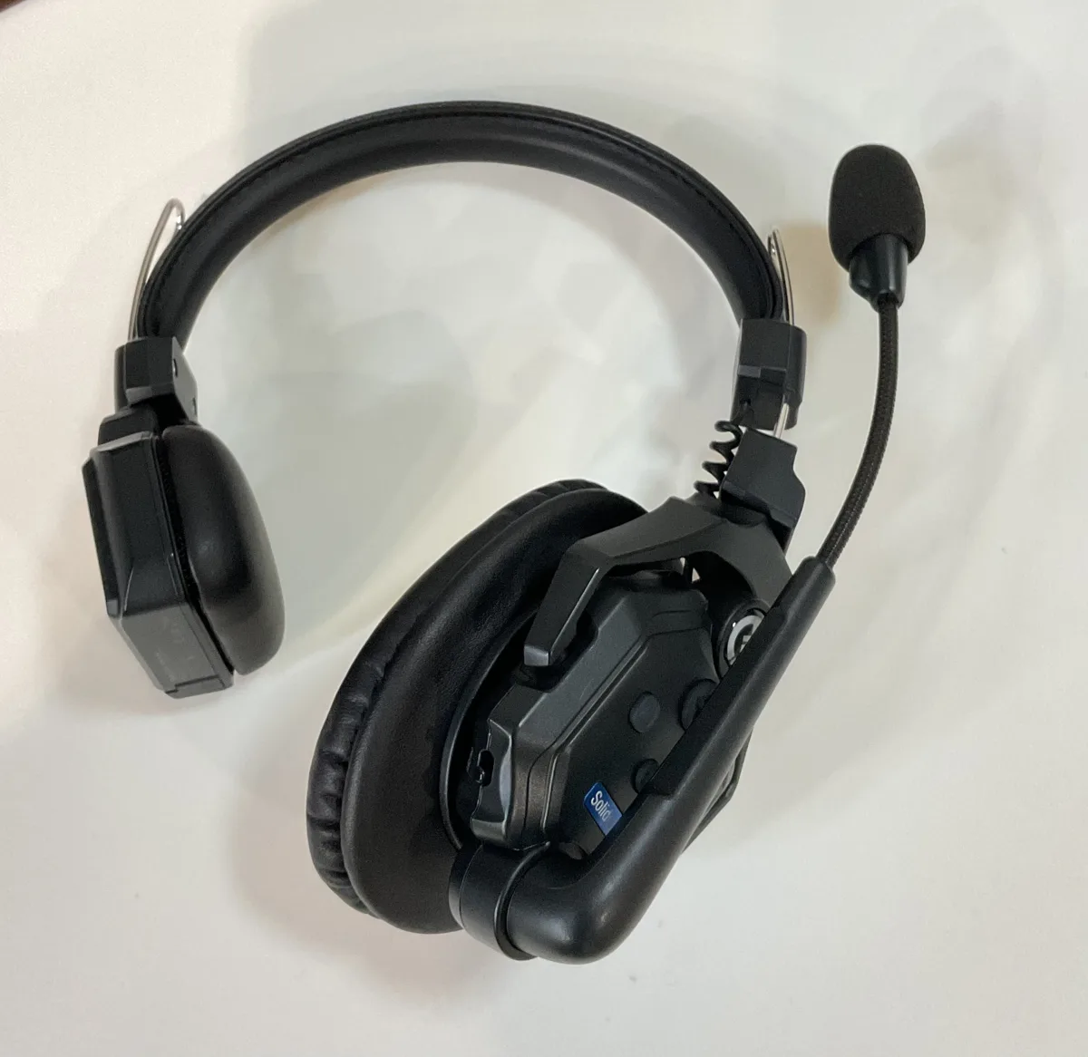 A Hollyland Solidcom wireless intercom remote headset with boom microphone